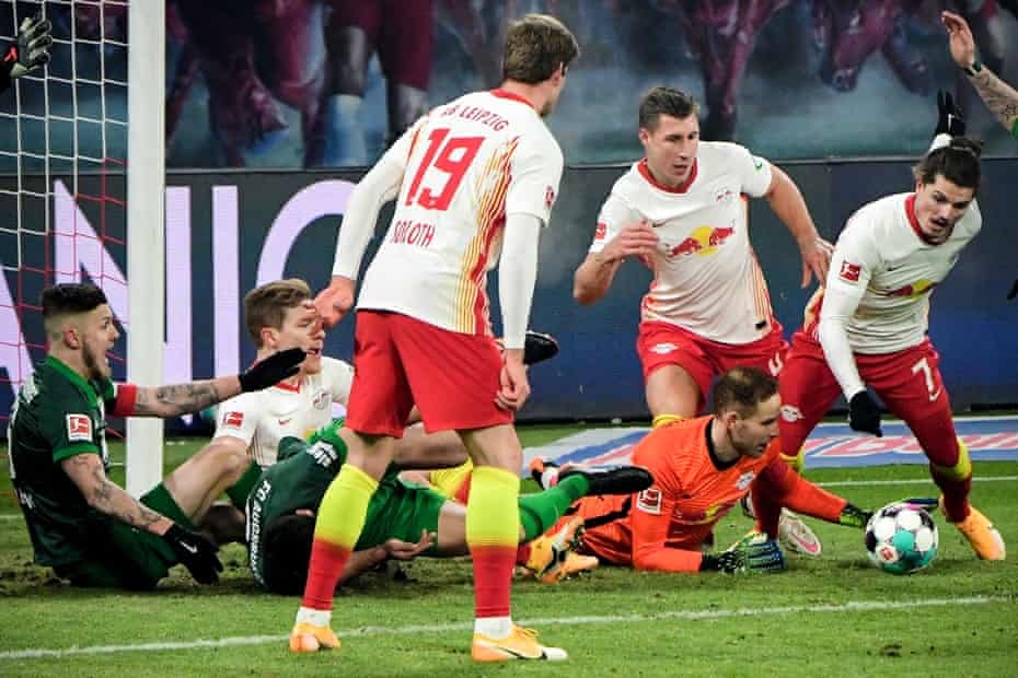 Leipzig’s former Liverpool goalkeeper Peter Gulacsi (bottom right) in action during the 2-1 victory over Augsburg on Friday.